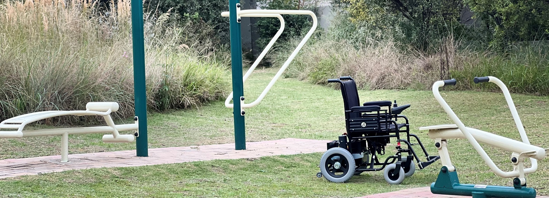 CE POwer wheelchair in an outdoor gym