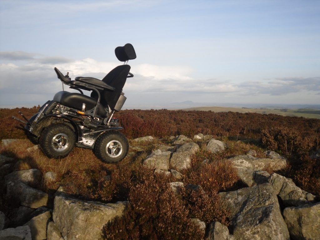 Off-road electric wheelchair navigating rocky terrain